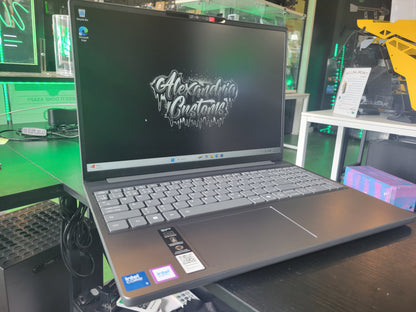 Laptop on a desk with a screen displaying 'Alexandria Customs' in a store setting.
