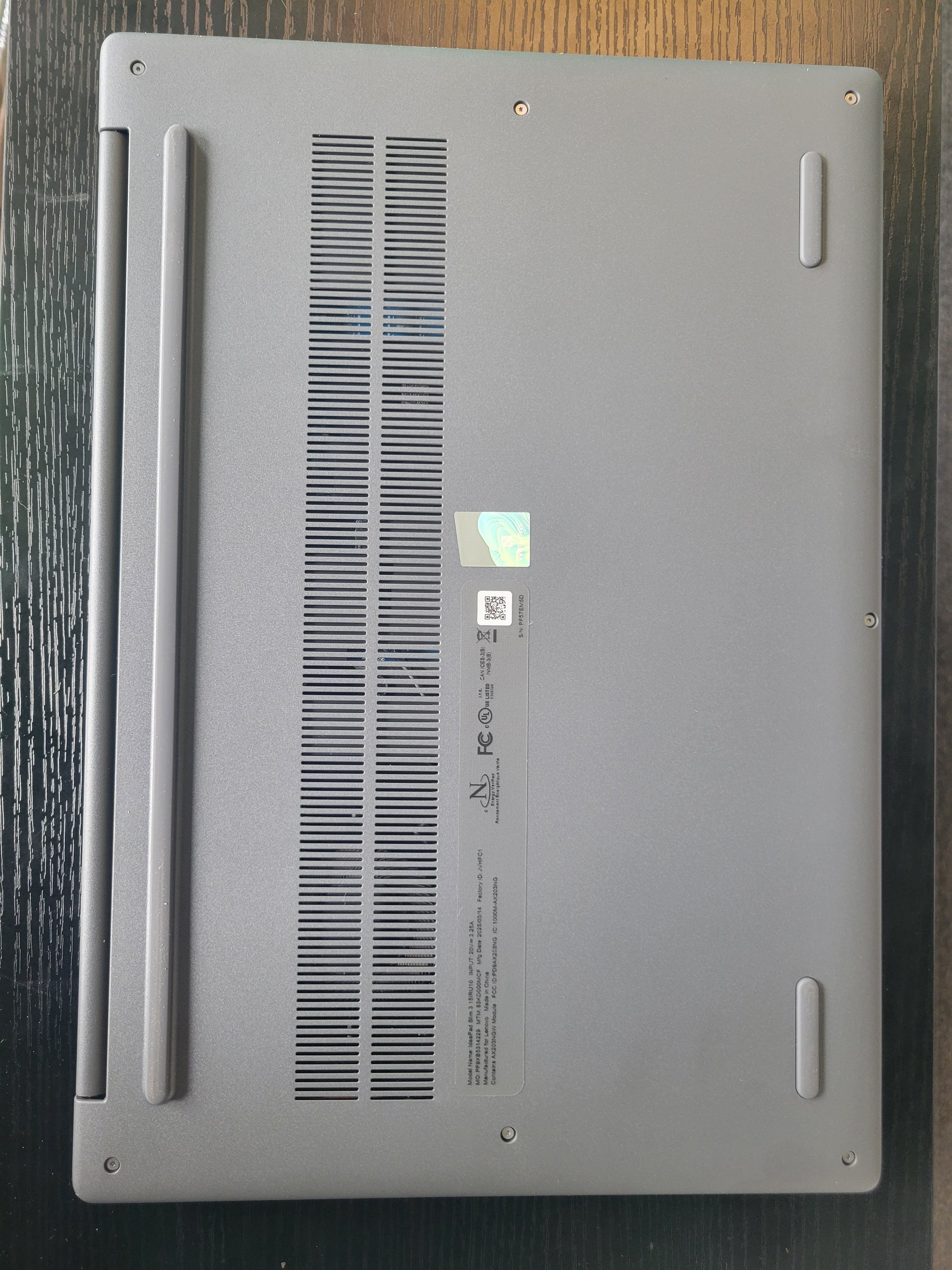 Back view of a laptop on a wooden surface