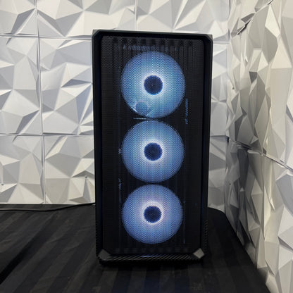 Computer case with three blue LED lights against a geometric-patterned wall.