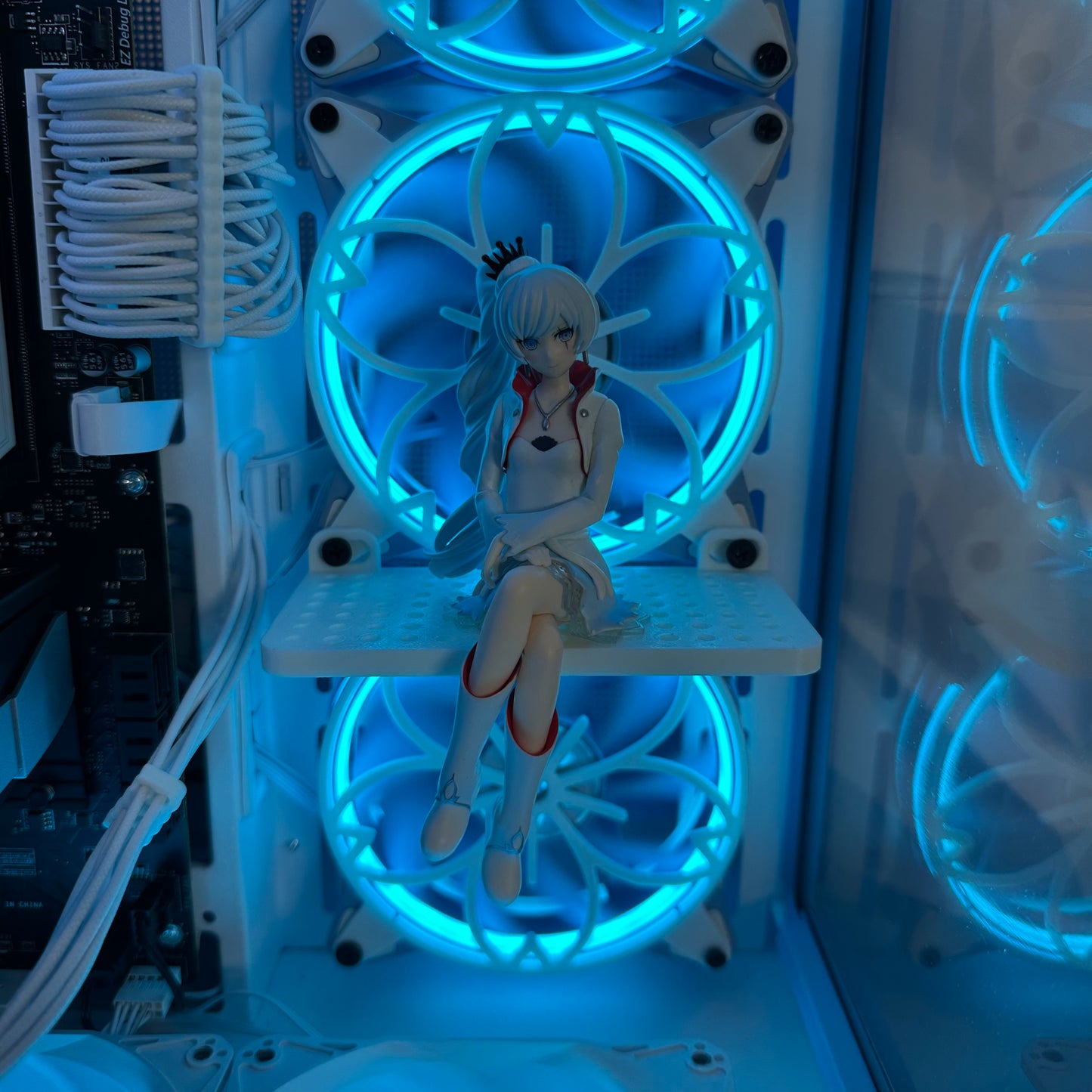 Anime figurine inside a computer case with glowing blue lights