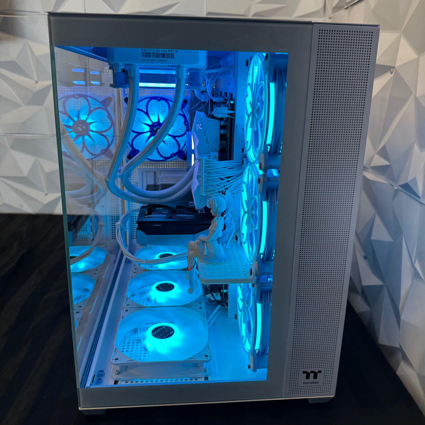 Computer case with blue LED lighting on a geometric patterned wall background