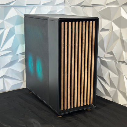 Black electronic device with wooden slats against a geometric-patterned wall.