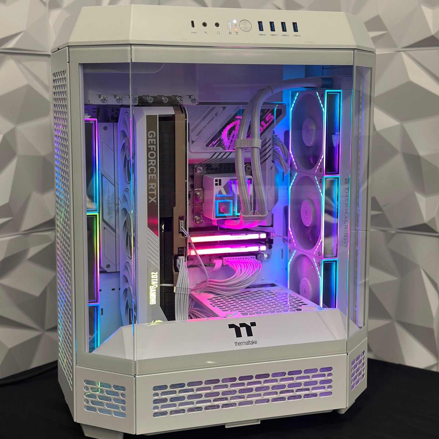 Computer case with RGB lighting on a geometric patterned wall background