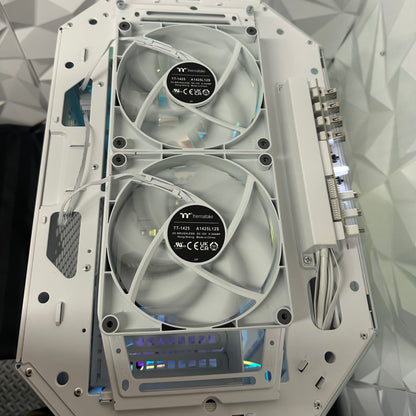 Computer case with two fans and visible branding on a geometric patterned background