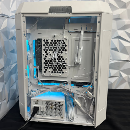 Computer case with open side panel showing internal components against a geometric patterned wall.