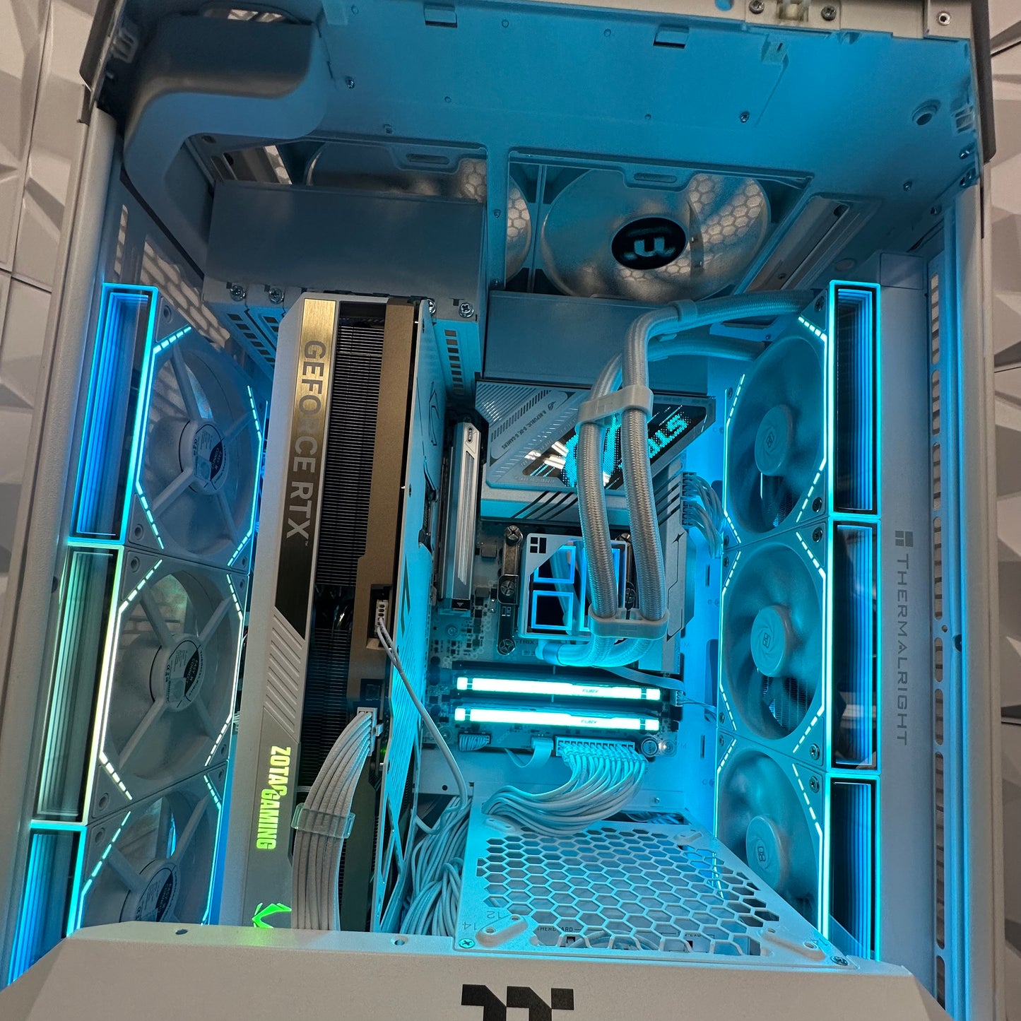 Open computer case with visible components and blue lighting
