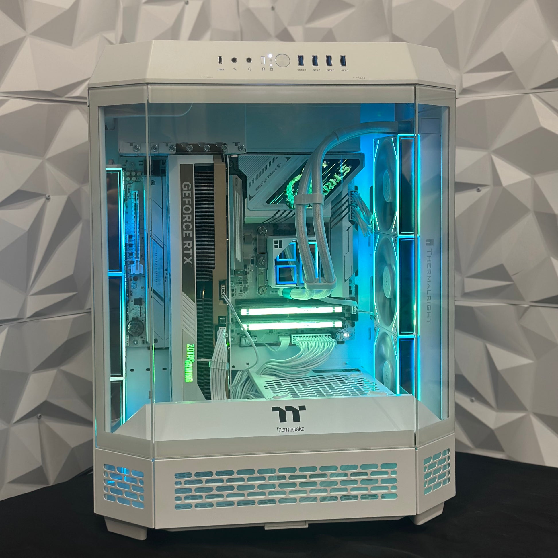 Computer graphics card inside a transparent computer case with a geometric patterned wall in the background