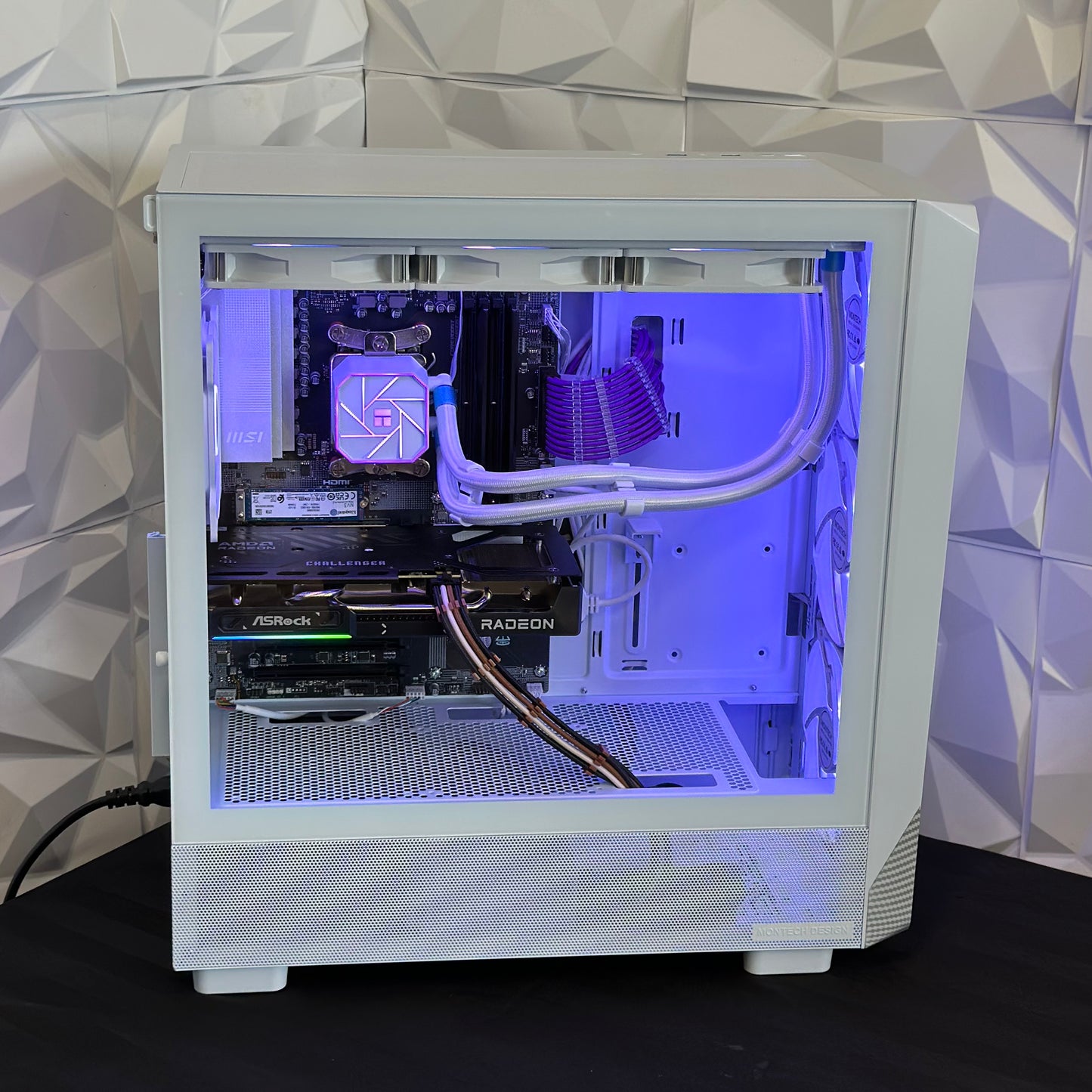 Computer case with visible internal components against a geometric-patterned wall.